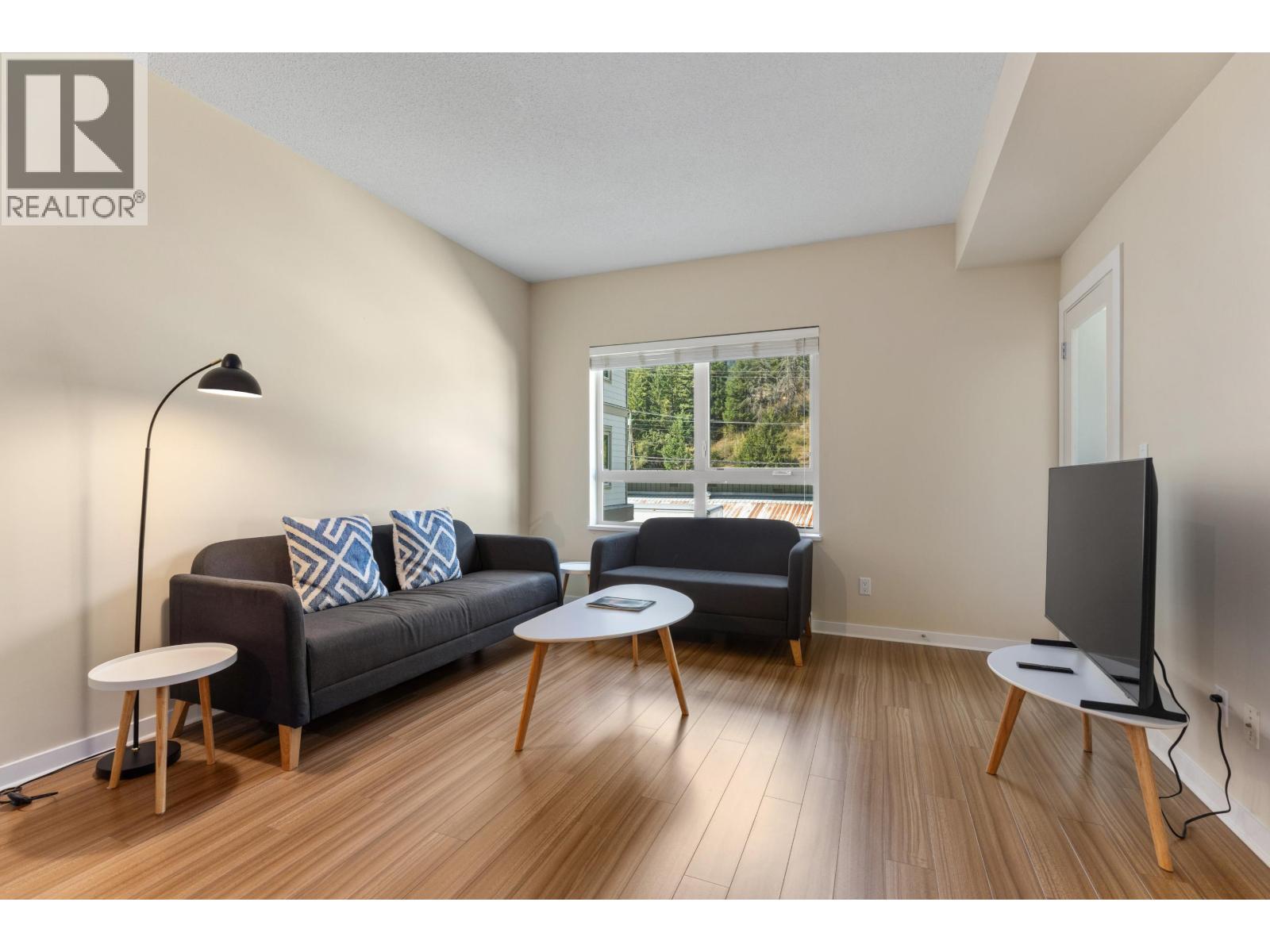 202 7445 FRONTIER STREET Property Photo 1